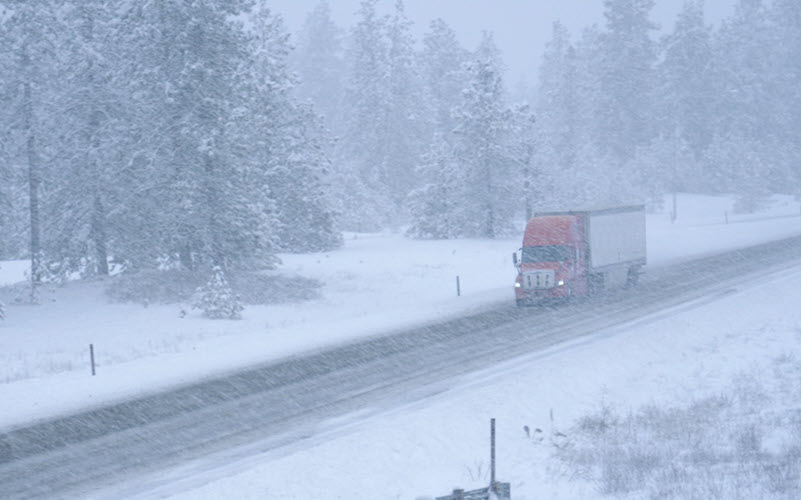Class A HD Tractor-Trailer friving with Tire Chains in Colorado Mountains